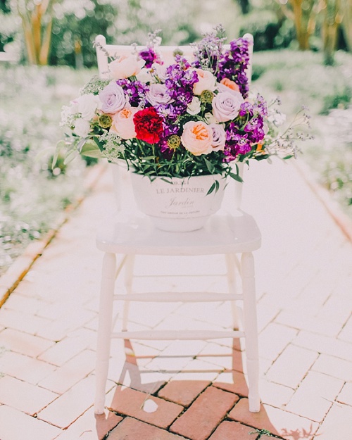 Gorgeous wedding and event floral designs and bouquets displayed on chairs. Paisley and Jade specializing in vintage and eclectic rentals for weddings trade shows photo shots or film and theatrical productions