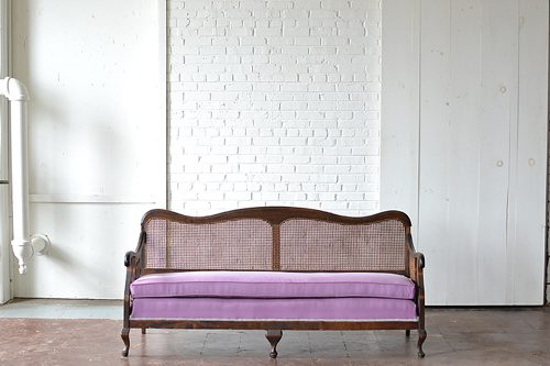 Vintage caned sofa with lilac ombre upholstery available for rent from Paisley and Jade 