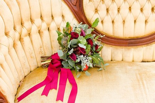 Beautiful winter inspired flowers on chairs moments with specialty and vintage rentals by Paisley & Jade