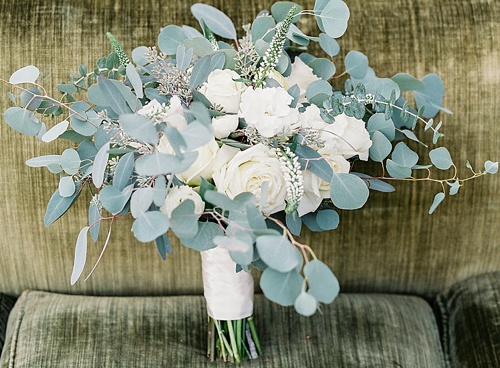Beautiful winter inspired flowers on chairs moments with specialty and vintage rentals by Paisley & Jade