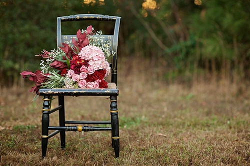 Beautiful winter inspired flowers on chairs moments with specialty and vintage rentals by Paisley & Jade