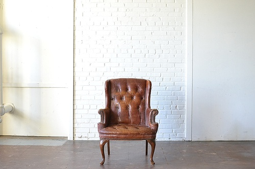 The Dalls leather upholstered chair available for rent by Paisley & Jade 