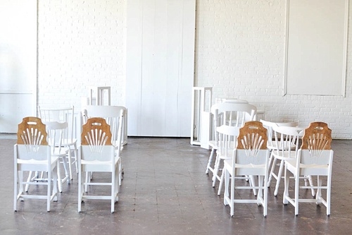 Inspiration Station wedding ceremony design featuring wooden pedestals and chairs available for rent by Paisley and Jade 