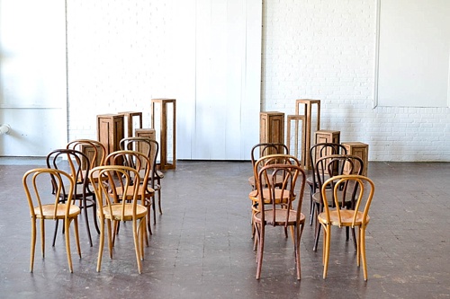 Inspiration Station wedding ceremony design featuring wooden pedestals and chairs available for rent by Paisley and Jade 