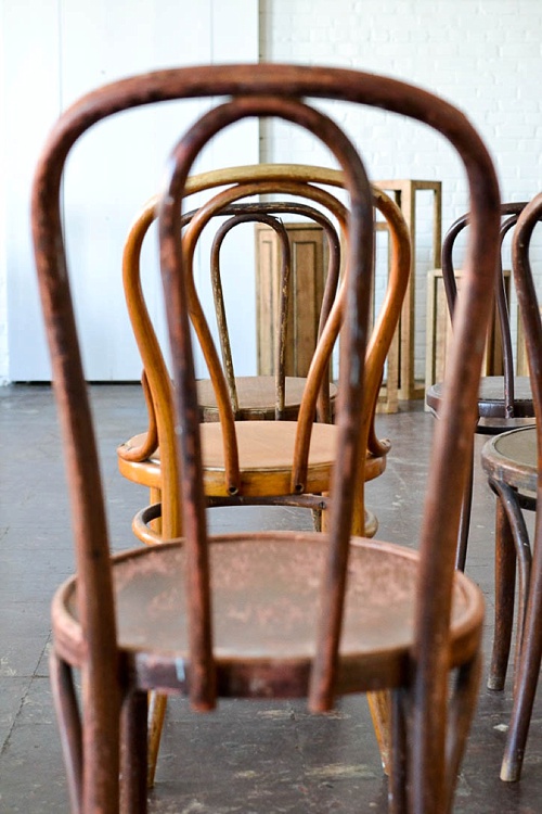 Inspiration Station wedding ceremony design featuring wooden pedestals and chairs available for rent by Paisley and Jade 