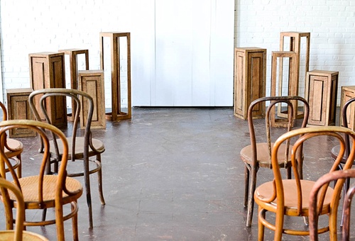 Inspiration Station wedding ceremony design featuring wooden pedestals and chairs available for rent by Paisley and Jade 