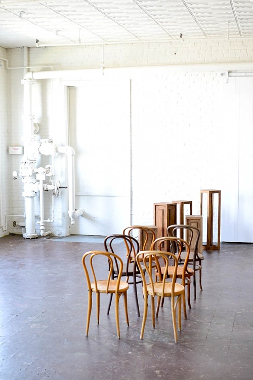 Inspiration Station wedding ceremony design featuring wooden pedestals and chairs available for rent by Paisley and Jade 