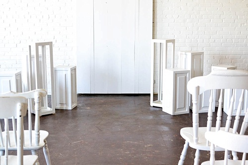 Inspiration Station wedding ceremony design featuring wooden pedestals and chairs available for rent by Paisley and Jade 