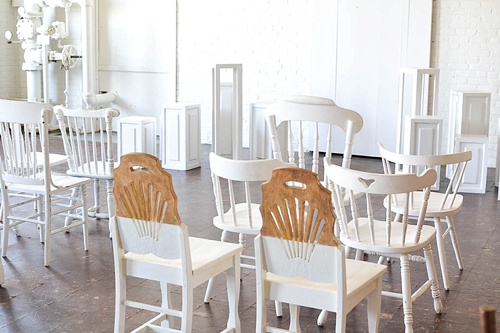 Inspiration Station wedding ceremony design featuring wooden pedestals and chairs available for rent by Paisley and Jade 