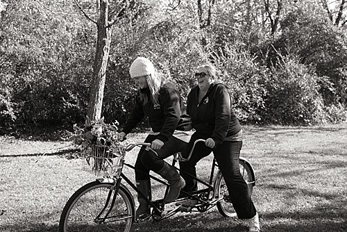 Co-Captains of Paisley & Jade, Morgan and Perkins, pedal on P&J's vintage Tandem Bicycle. 