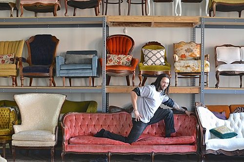 Paisley & Jade's Warehouse Manager poses for the photographer on a vintage upholstered couch! 