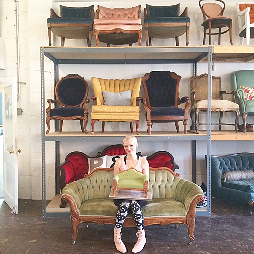 Amanda from Sweet Fix poses on the Thurmont, a victorian style settee upholstered in soft sage green velvet with pretty carved wood details. This settee is perfect for lounge areas, sweetheart seating, photo shoots, or cakes! 