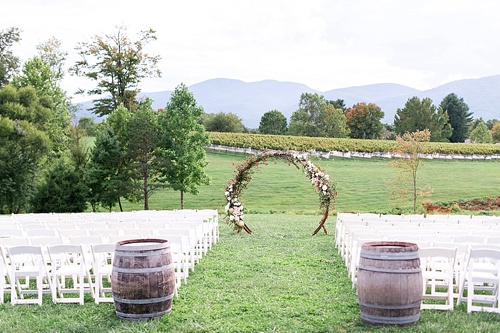 Romantic summer outdoor winery wedding with wooden arbor available for rent by Paisley and Jade