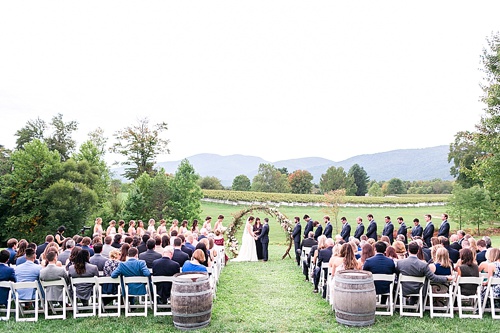 Romantic summer outdoor winery wedding with wooden arbor available for rent by Paisley and Jade