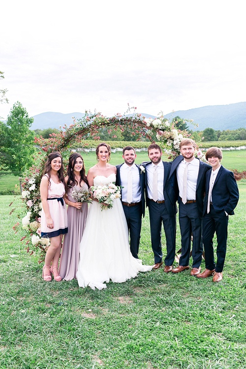 Romantic summer outdoor winery wedding with wooden arbor available for rent by Paisley and Jade