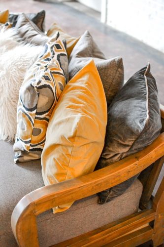 Styling with colorful and chic pillows at Highpoint & Moore with inventory, space and design by Paisley & Jade 